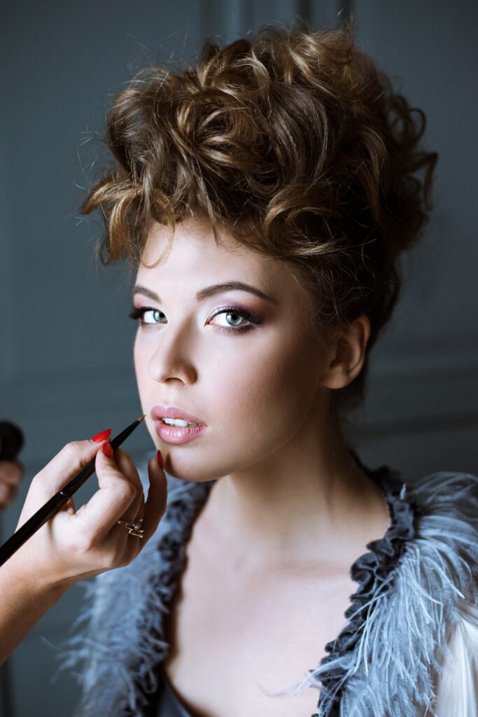 Wedding makeup artist making a make up for bride